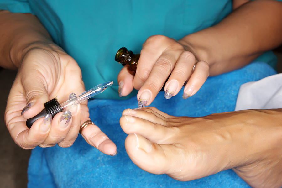 A woman is getting a pedicure on her toes.